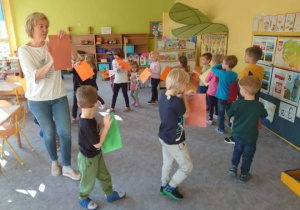 Dzieci grają na kolorowych kartkach papieru