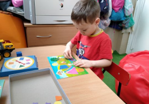Chłopiec uzupełnia brakujące elementy obrazka