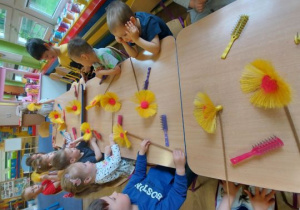 Dzieci wykonuja kwiaty z sizalu