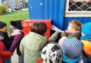 Dzieci wrzucają list do skrzynki pocztowej