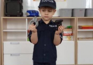 Chłopiec prezentuje strój policjanta