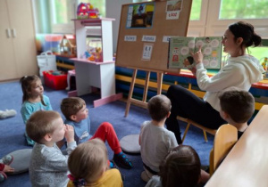 Dzieci słuchają opowiadania nauczyciela